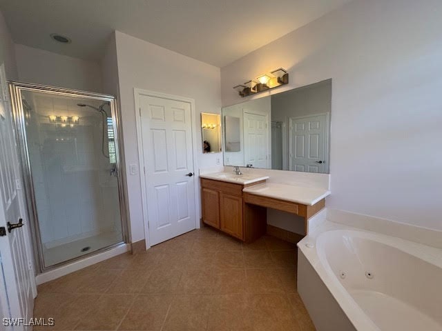 bathroom featuring tile patterned flooring, vanity, and independent shower and bath