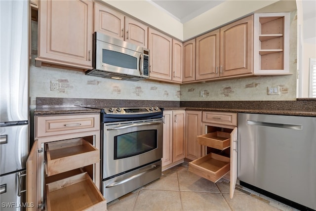 kitchen with light brown cabinets, light tile patterned floors, appliances with stainless steel finishes, and tasteful backsplash