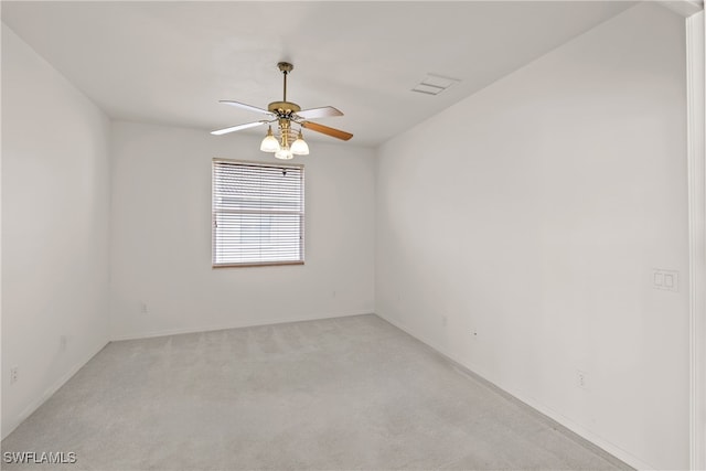 unfurnished room featuring light carpet and ceiling fan