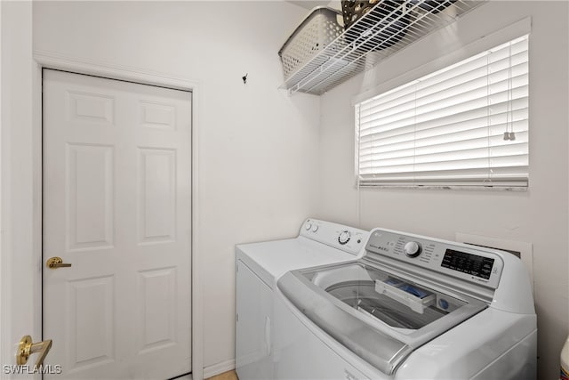 clothes washing area with separate washer and dryer