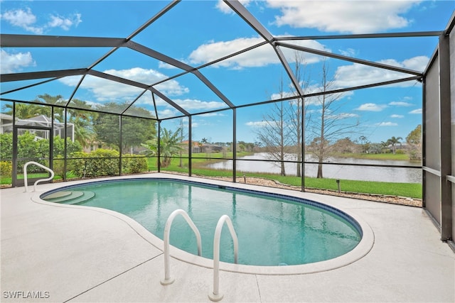 view of pool with glass enclosure, a patio area, and a water view