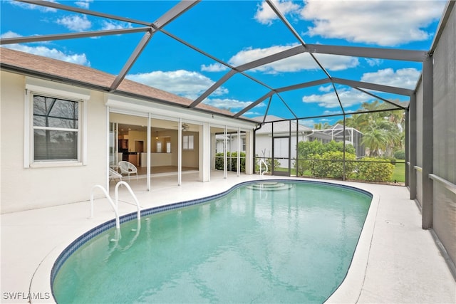 view of pool with ceiling fan, a patio area, and a lanai