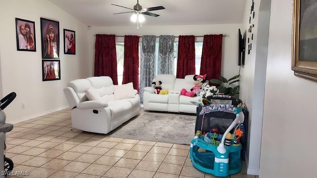 living room featuring ceiling fan, plenty of natural light, light tile patterned floors, and vaulted ceiling