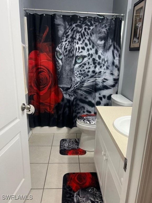 bathroom featuring tile patterned flooring, vanity, toilet, and a shower with shower curtain