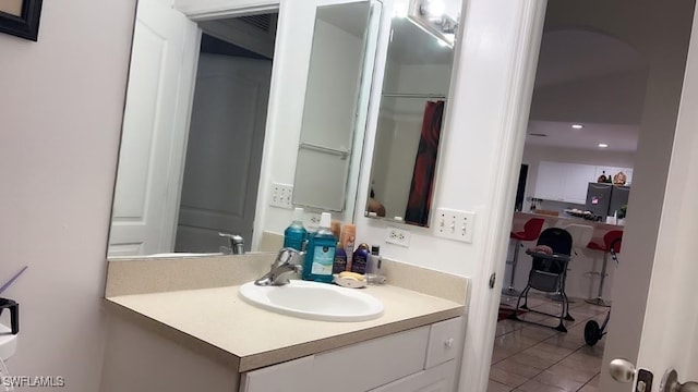 bathroom featuring tile patterned flooring and vanity