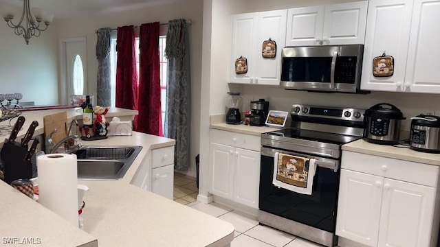 kitchen with sink, white cabinets, and stainless steel appliances