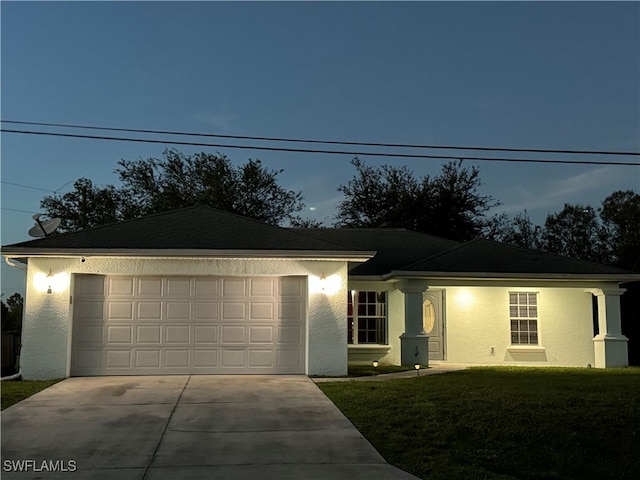 ranch-style house with a yard and a garage