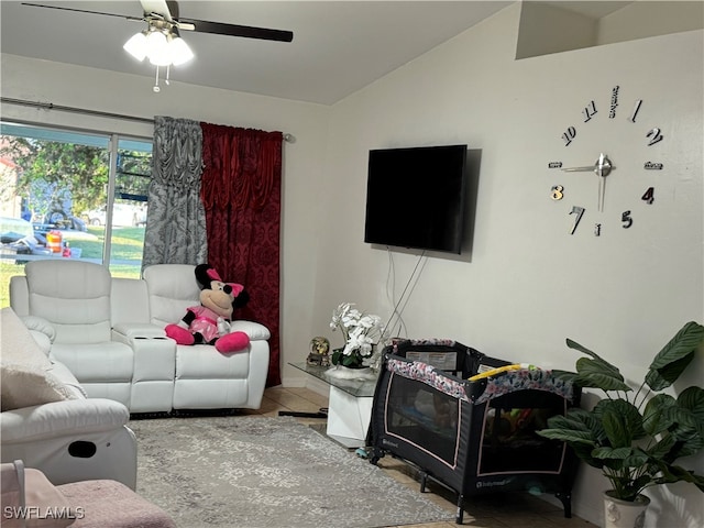 tiled living room with ceiling fan and lofted ceiling