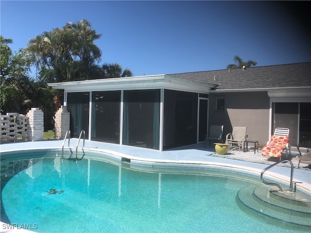 view of pool featuring a patio and a sunroom