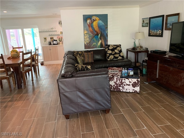 living room with ornamental molding and dark hardwood / wood-style floors