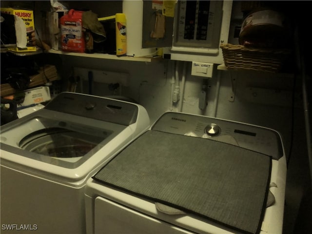 laundry area featuring electric panel and separate washer and dryer