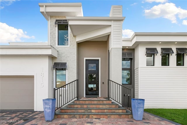 doorway to property with a garage