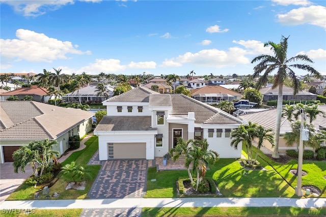 view of front of house with a front lawn and a garage