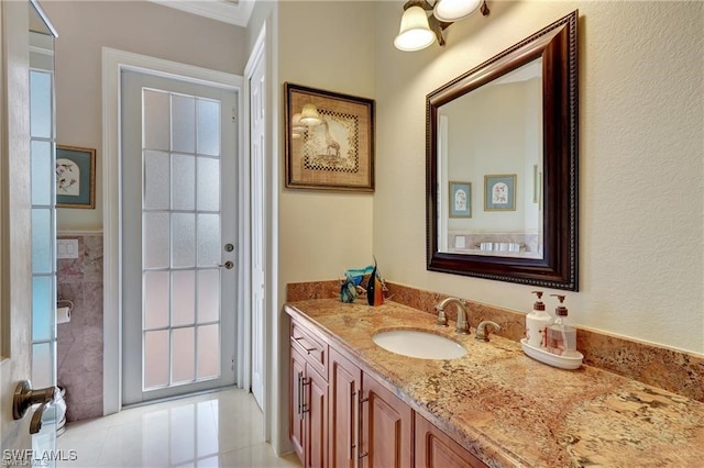 bathroom featuring vanity and tile walls