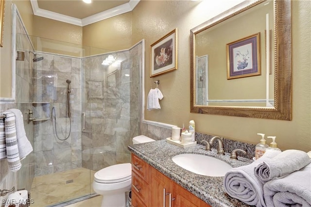 bathroom featuring ornamental molding, toilet, a shower with shower door, and vanity