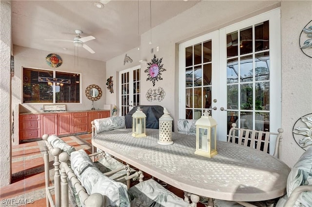 tiled dining area featuring french doors and ceiling fan