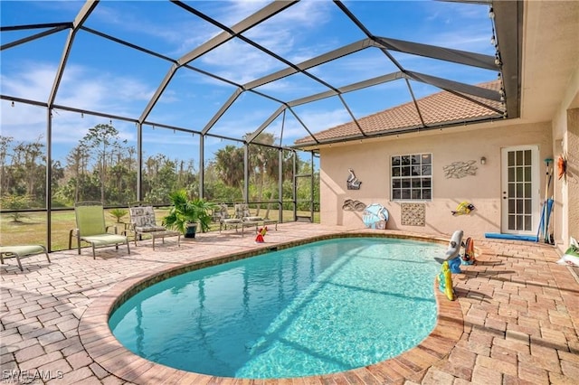 view of pool with a lanai and a patio area