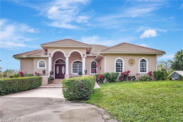 mediterranean / spanish-style home with a front yard