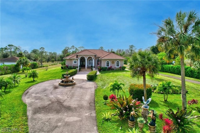 mediterranean / spanish-style house with a front lawn