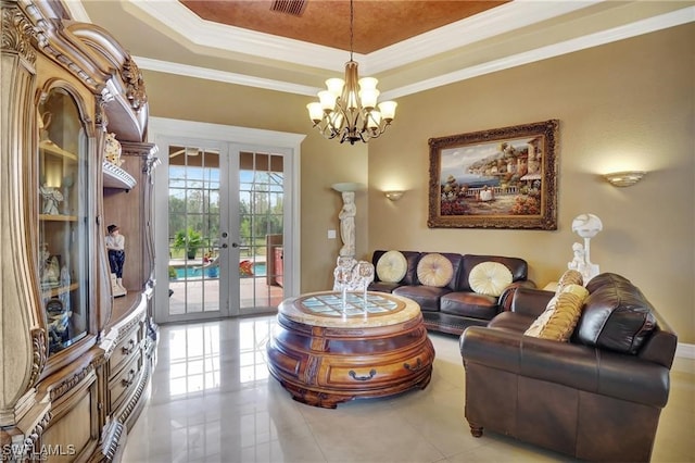 tiled living room featuring a chandelier, ornamental molding, french doors, and a raised ceiling