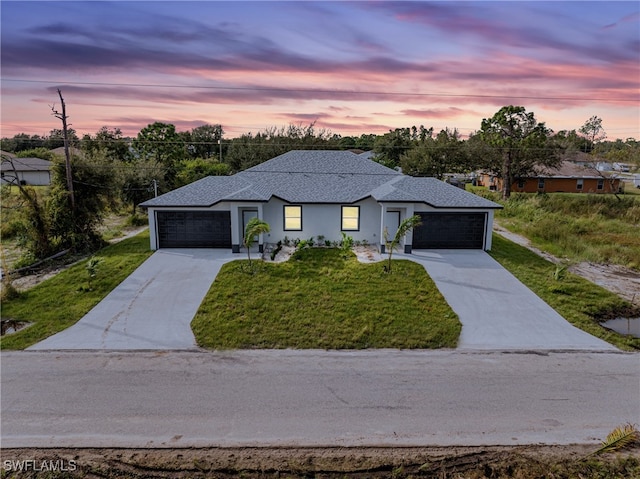 prairie-style home with a lawn and a garage