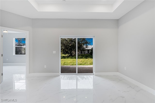 spare room with a tray ceiling