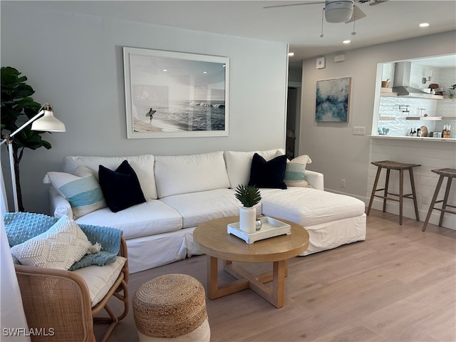 living room with ceiling fan and light hardwood / wood-style floors