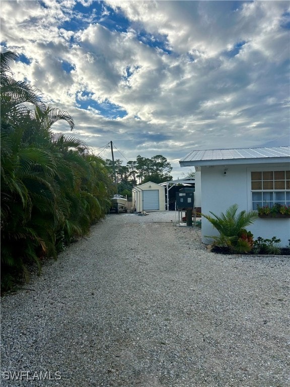 view of side of property with a garage and an outdoor structure