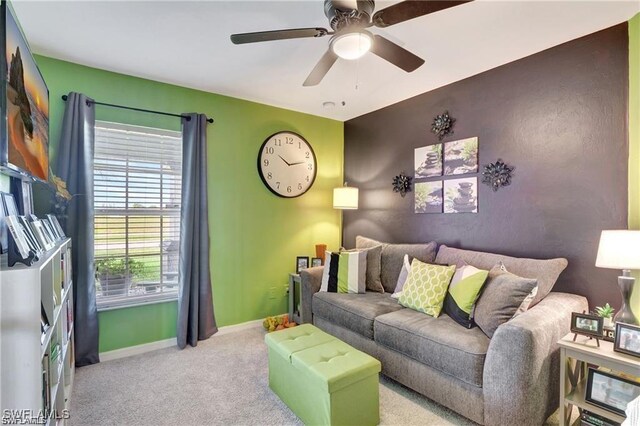 living room with light carpet and ceiling fan