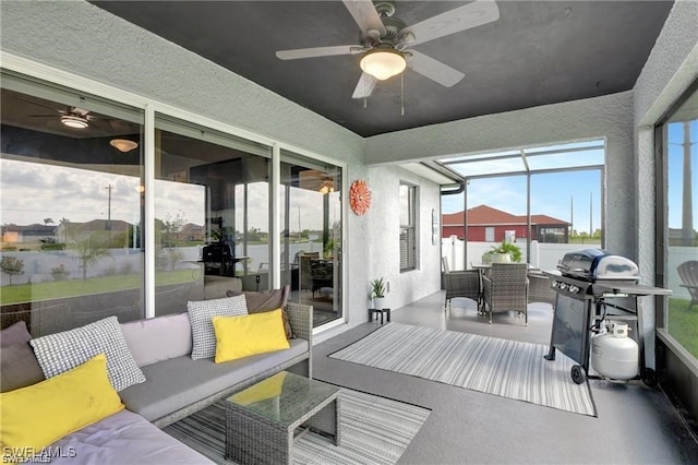 sunroom / solarium featuring ceiling fan