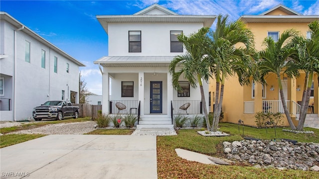 view of front of house featuring covered porch and a front lawn