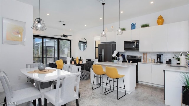 3016 Van Buren Ave, Naples, FL 34112 - kitchen with refrigerator with ice dispenser, electric range, a sink, tasteful backsplash, and a kitchen island
