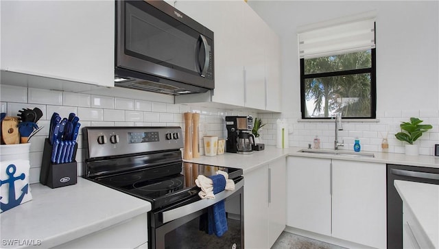 3016 Van Buren Ave, Naples, FL 34112 - kitchen featuring stainless steel appliances, a sink, white cabinetry, and light countertops