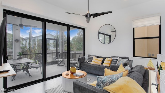 living room featuring concrete floors and ceiling fan