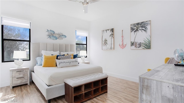 bedroom with hardwood / wood-style floors and ceiling fan