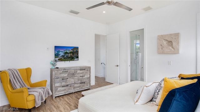 bedroom featuring ceiling fan, wood-type flooring, and ensuite bathroom