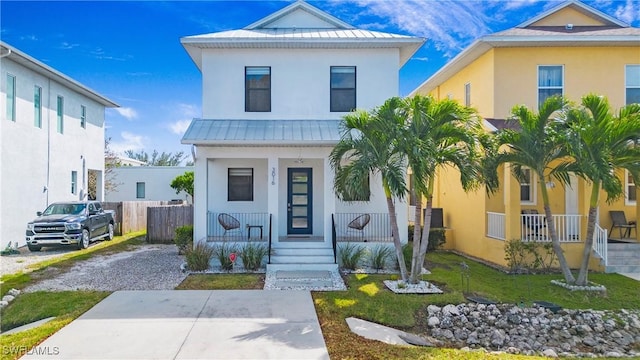 3016 Van Buren Ave, Naples, FL 34112 - view of front facade featuring a porch, stucco siding, metal roof, and a standing seam roof