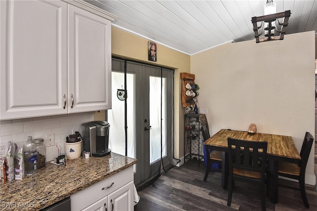 kitchen featuring dark wood-type flooring, french doors, white cabinets, decorative backsplash, and dark stone countertops