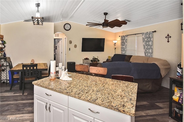 interior space with white cabinets, dark wood-type flooring, ceiling fan, and lofted ceiling