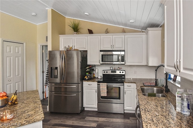 kitchen featuring white cabinets, sink, dark stone countertops, and stainless steel appliances