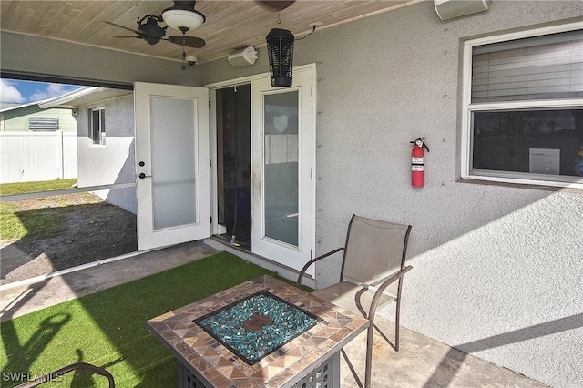 view of exterior entry with ceiling fan