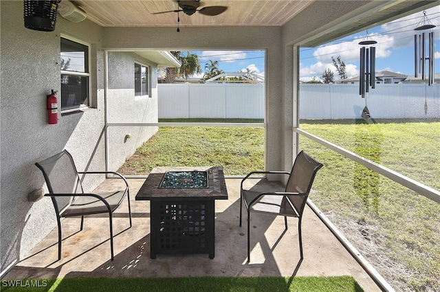 exterior space with a fire pit and ceiling fan