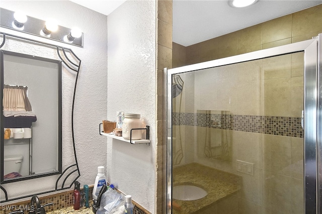 bathroom with vanity and an enclosed shower