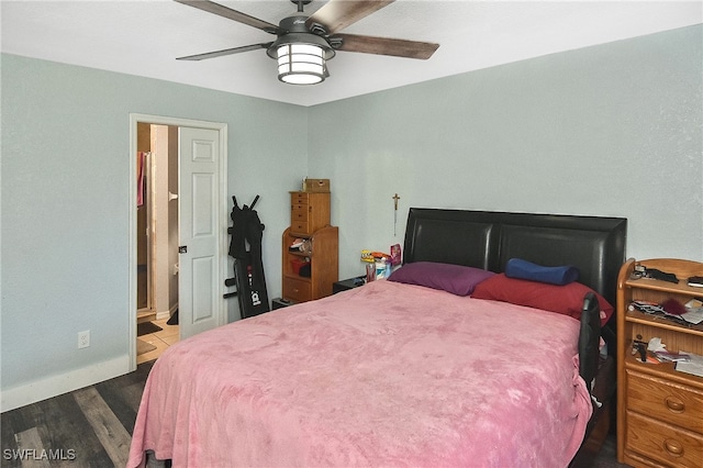 bedroom featuring ceiling fan, ensuite bathroom, and dark hardwood / wood-style floors