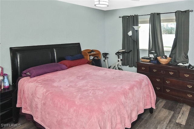 bedroom featuring dark hardwood / wood-style flooring