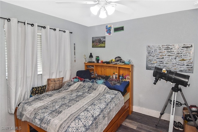 bedroom with dark hardwood / wood-style floors and ceiling fan