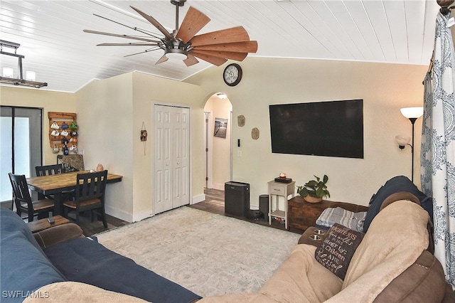 living room featuring lofted ceiling, ceiling fan, light wood-type flooring, and wooden ceiling