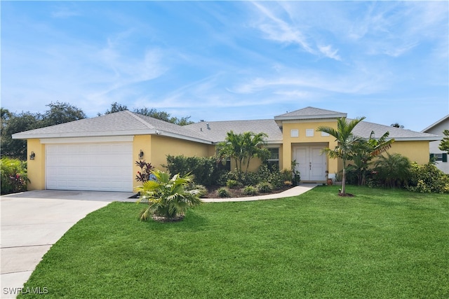 view of front of house with a front lawn and a garage