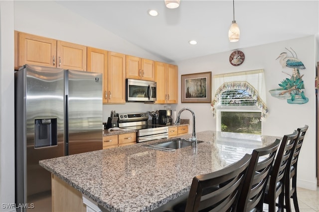 176 Venus Cay Cay, Naples, FL 34114 - kitchen with stainless steel appliances, lofted ceiling, hanging light fixtures, sink, and a breakfast bar area