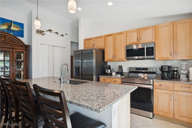 176 Venus Cay Cay, Naples, FL 34114 - kitchen with a kitchen breakfast bar, stainless steel appliances, a center island with sink, and vaulted ceiling